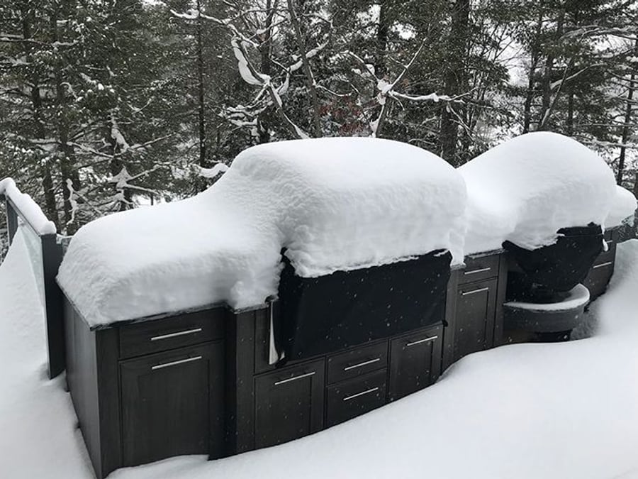 NatureKast weatherproof outdoor kitchen cabinetry buried under heavy snow